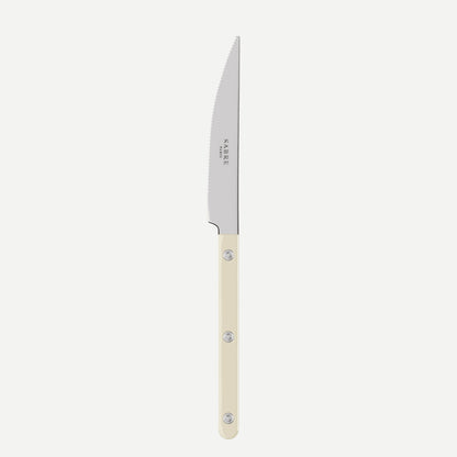 Knife with a white handle on a light beige background